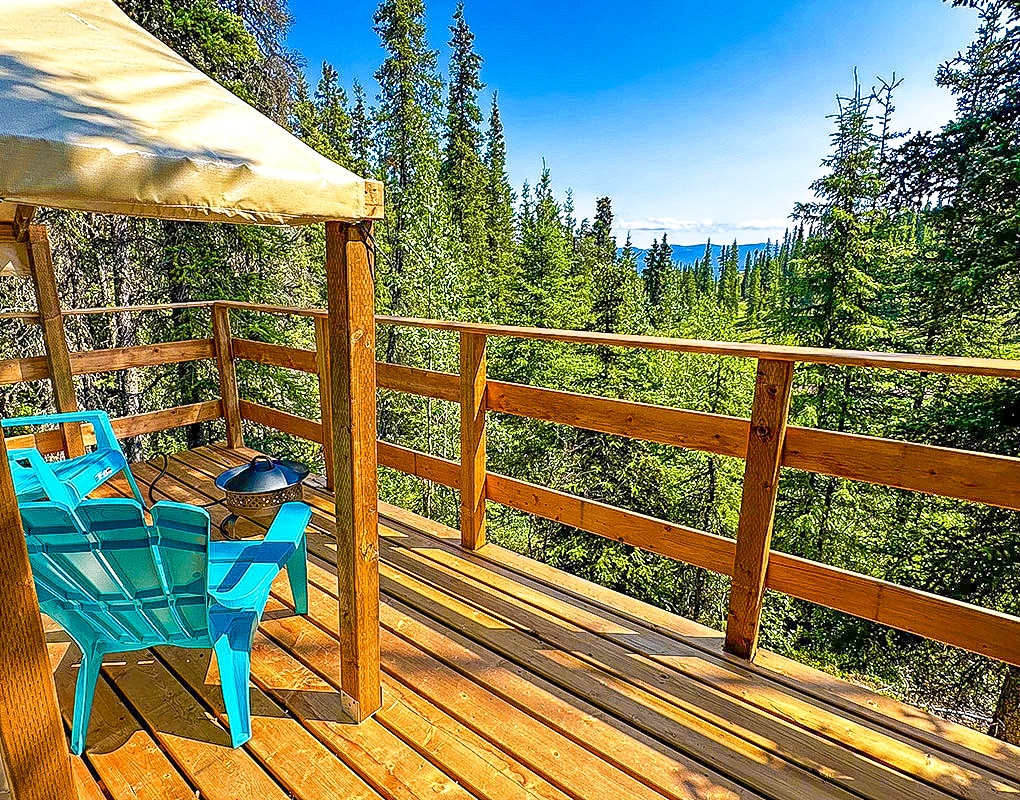 a deck with a chair and a table