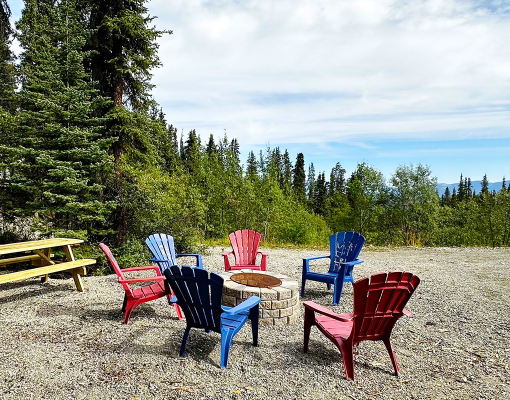 a group of chairs around a fire pit