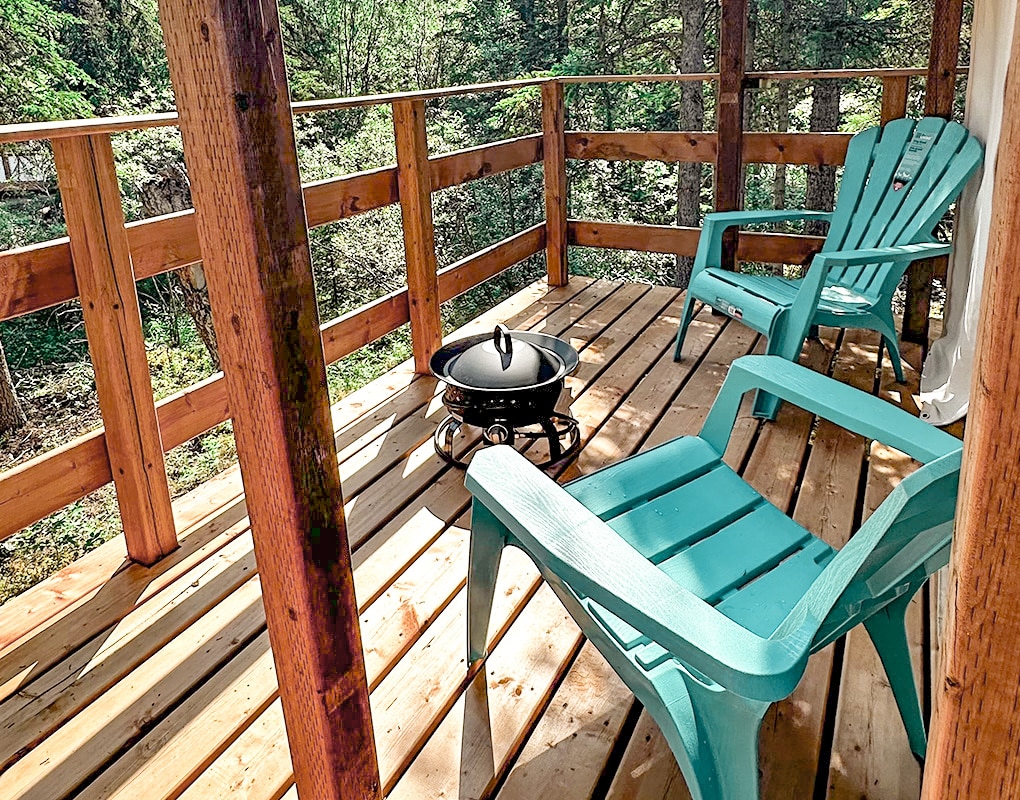 a deck with chairs and a grill