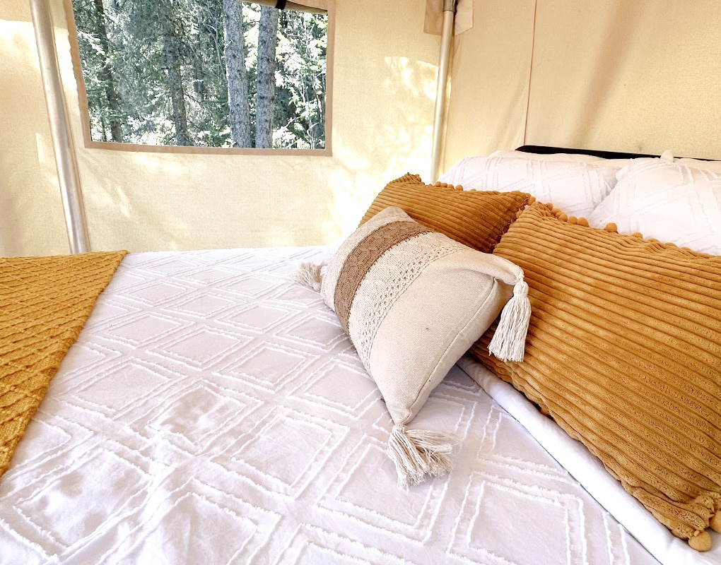a bed with pillows and blankets