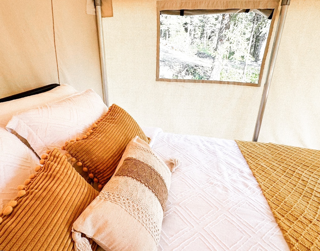 a bed with pillows and blankets