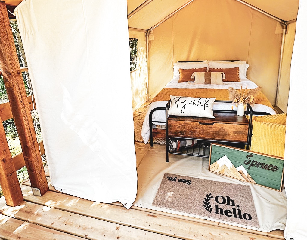 a bed and a table in a tent