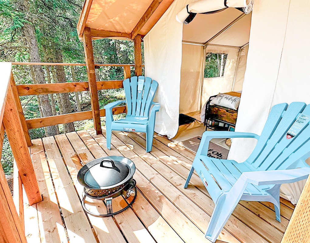 a deck with chairs and a grill