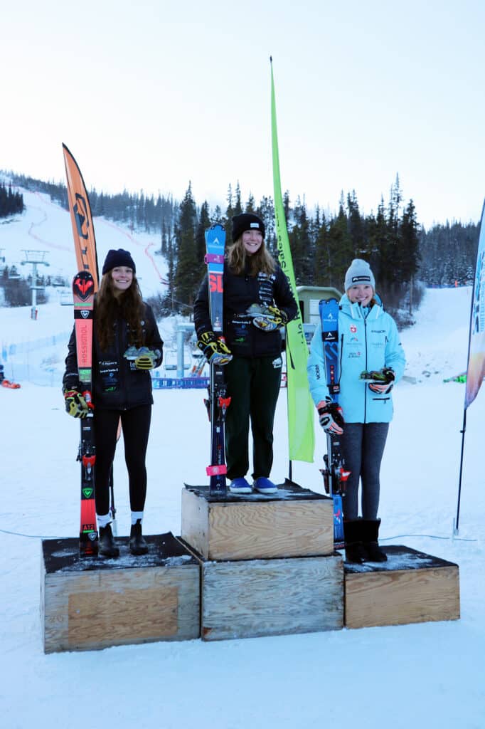 a group of people standing on a podium with skis